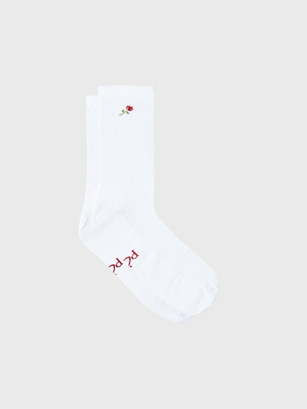 Pair of white POP Cycling Co. socks with red rose flower pattern laid flat, showing reinforced heel.