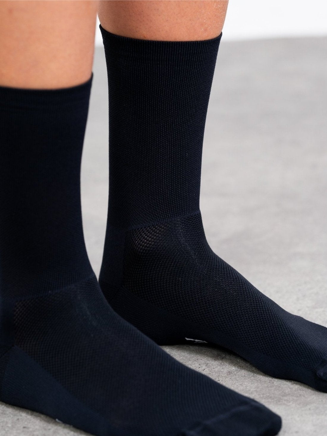 Pure black seamless cycling socks designed for durability and dirt resistance. Logo-free styling with reinforced heel and toe.
